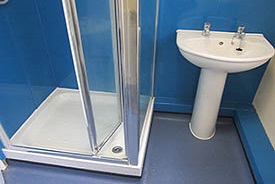 A bathroom with a shower cubicle and a sink.