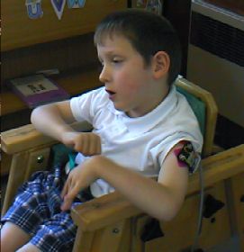 Child L wearing the muscle sensor on his upper arm