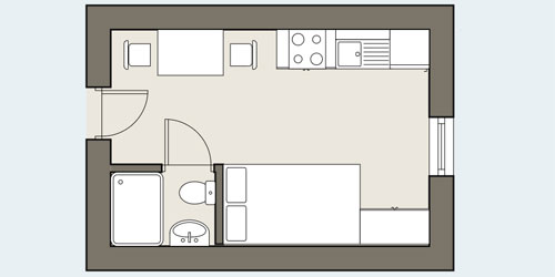 Floor plan of a room with an en suite bathroom in the corner to the right of the door into the room, and a table and chair in the left corner. There is a wardrobe in the far right corner from the door, and a kitchenette with a hob and sink in the far left corner. There is a double bed against the wall between the wardrobe and the bathroom.