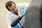 Researcher using a heat gun