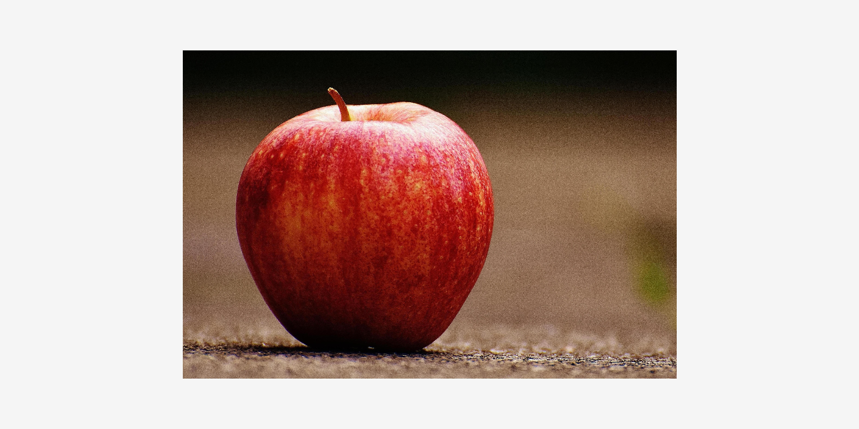 A close-up photograph of a red apple.