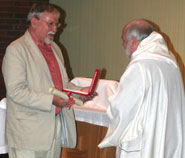 Mervyn Davies (left) is presented with his award by Revd Dr Jonathan Pye, Principal of Wesley College and a Research Fellow in the University’s Centre for Medical Ethics, on behalf of Rt Revd Declan Lang, Bishop of Clifton.