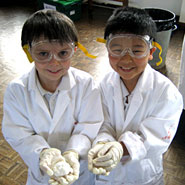 Two pupils from Moss Hall school taking part in a science workshop