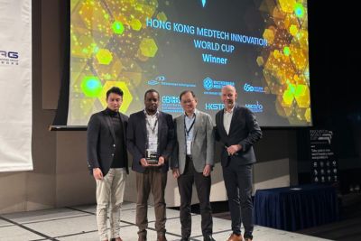 Photograph of FluoretiQ CEO on stage after winning first place at Innovation Awards in Hong Kong