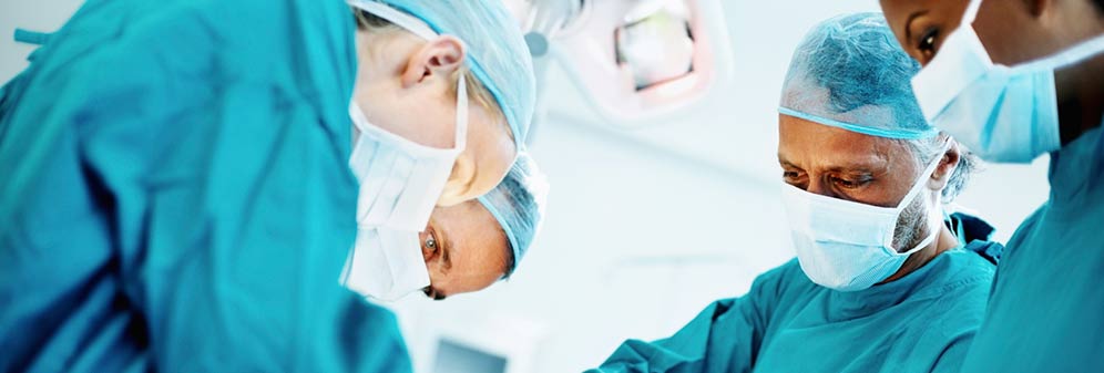 Four racially diverse doctors performing an operation.