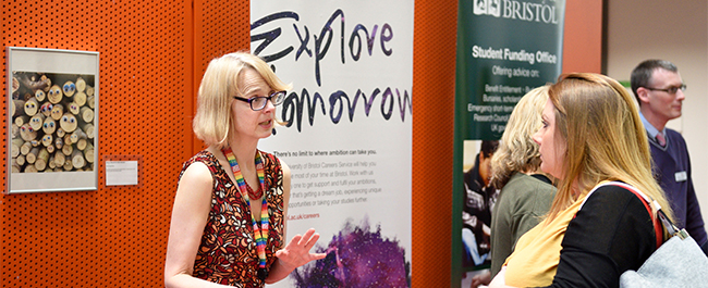 A Bristol careers advisor talking to a student at a fair.