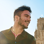 Headshot of smiling student with Wills Memorial Building in the background.