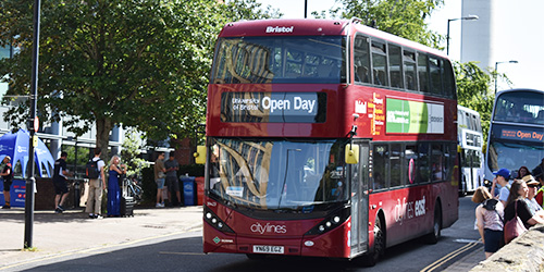 The front of a red double decker bus with 'University of Bristol open day' written on the front