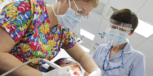 A participant has their teeth cleaned