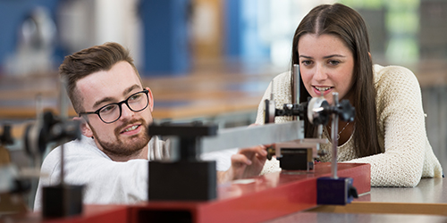 Two students work together in an engineering lab