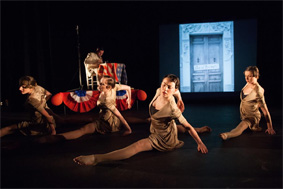 Four female students dancing on stage.