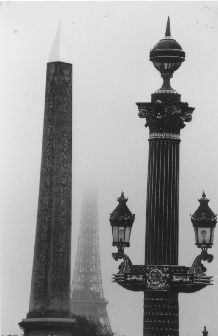 a view of a lampost, an obelisk and the Eiffel Tower
