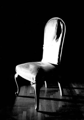 photograph of a chair in sunlight and shadow