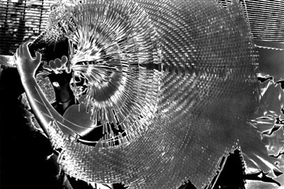 Photograph: polarised figure obscured by a wicker fan