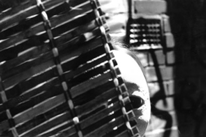 photograph: masked figure hiding behind a blind