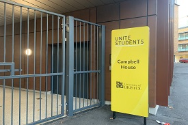 Outdoor gates to Campbell House on the left and the welcome sign to the residence on the right. These are security gates to make sure only residents and staff can enter the property.