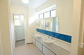 A bathroom with two sinks and mirrors.