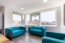 A room with two sofas and an armchair arranged in a semi-circle.