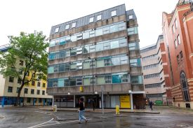 The exterior of a six-storey modern building with a sign at the entrance saying 'The Rackhay'.