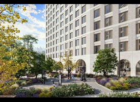 A landscaped courtyard beside a modern residential building, featuring outdoor exercise equipment, mature trees and colourful flowerbeds.&rdquo;