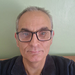 Mick, a man with short grey hair and glasses.