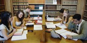 People looking over paperwork in library