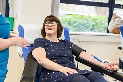 Lynn Molloy, COO of CO90s, giving blood