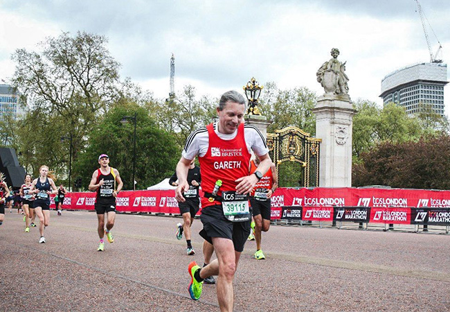 A runner representing the University in the London Marathon race.