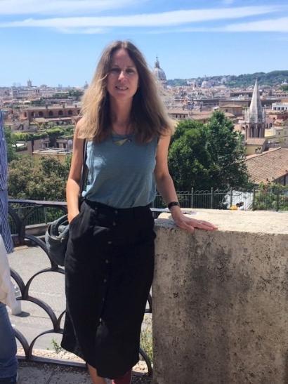 A photograph of Dr Laura Jansen standing in front of a cityscape.