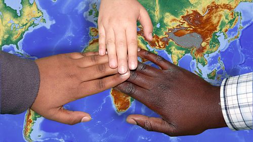 Hands on a world map