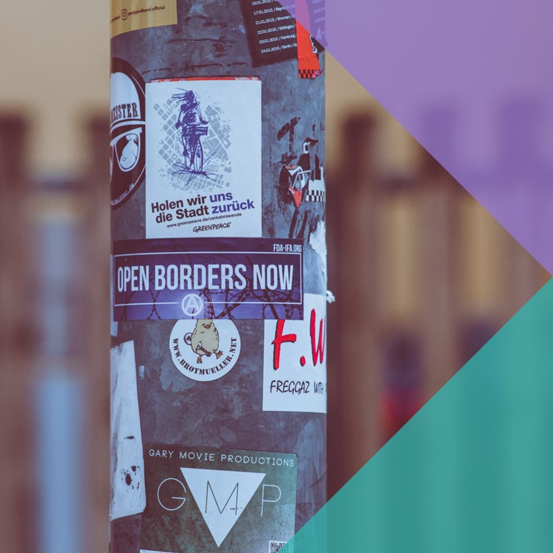 Protest stickers on a lamppost calling to 