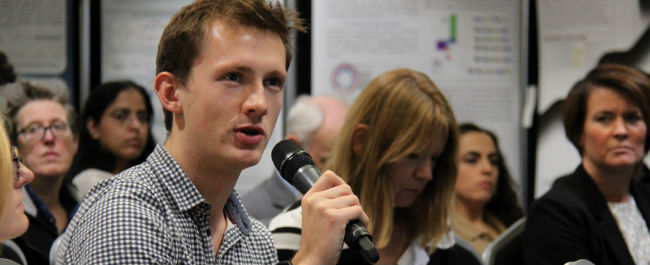man at conference asks questions