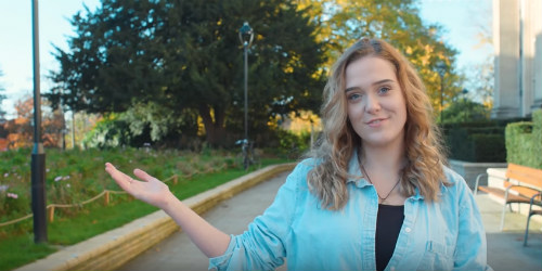 Smiling student talking to camera.