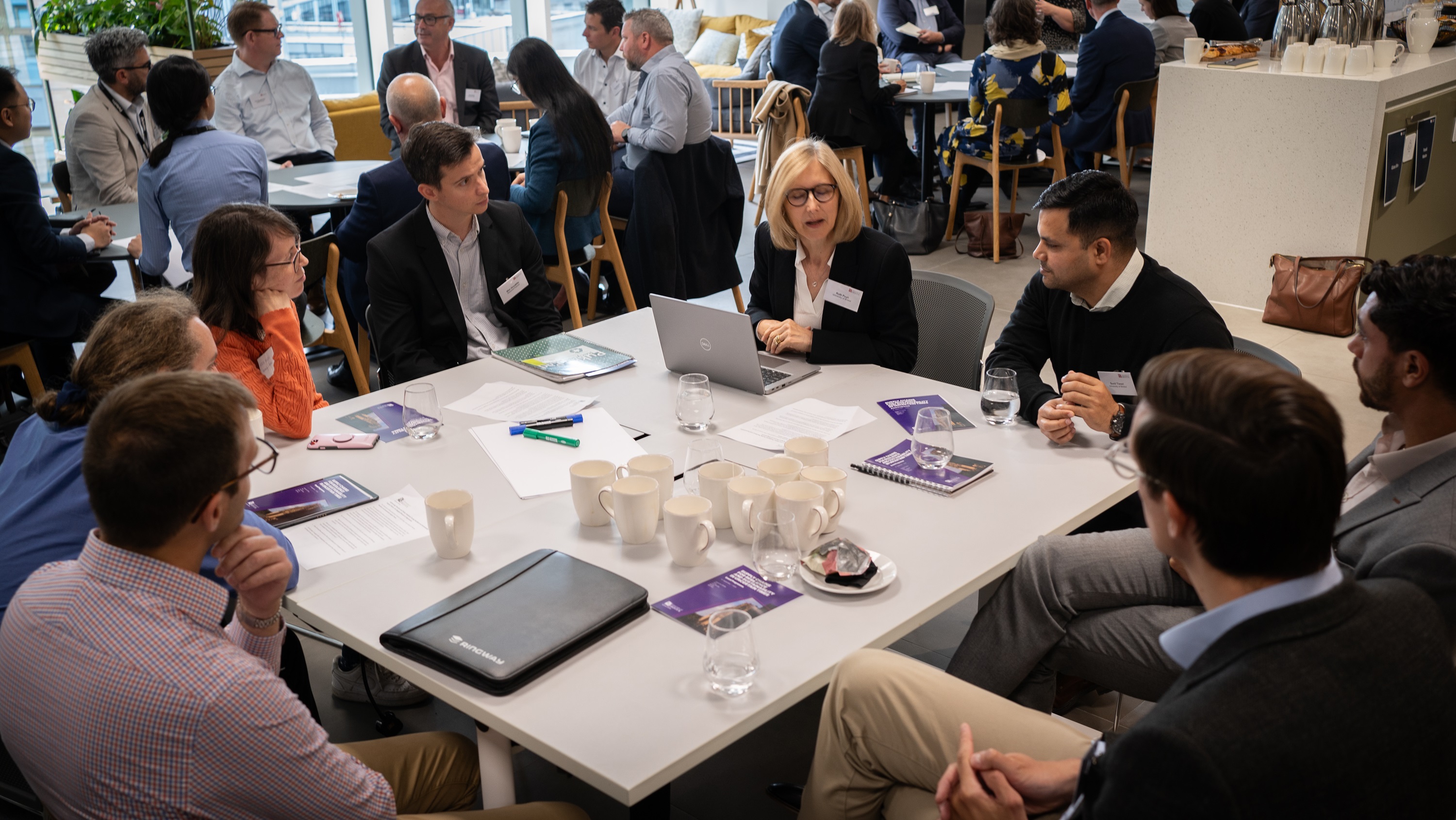 A group of people discussing around a table