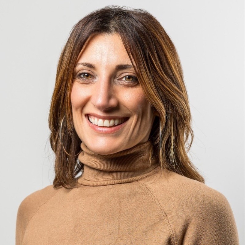 A head and shoulder image of a smiling woman