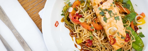 Close up of a meal of salmon and noodles