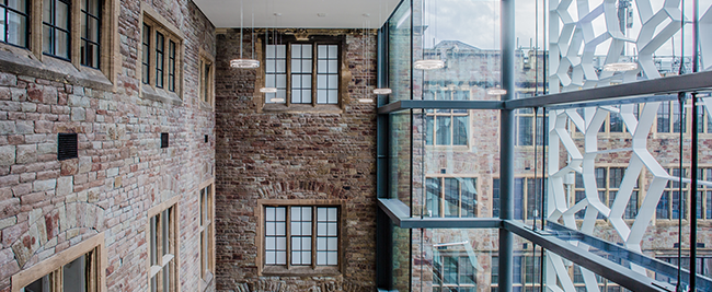 A brick wall next to a large window