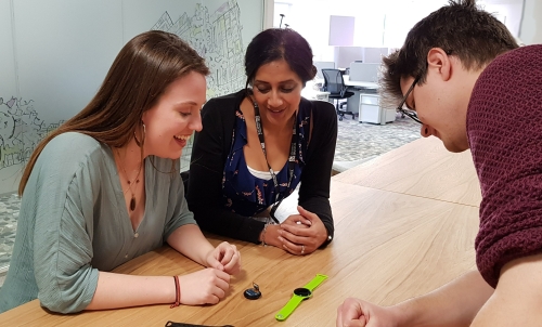 Digital Health students looking at a wearable device 
