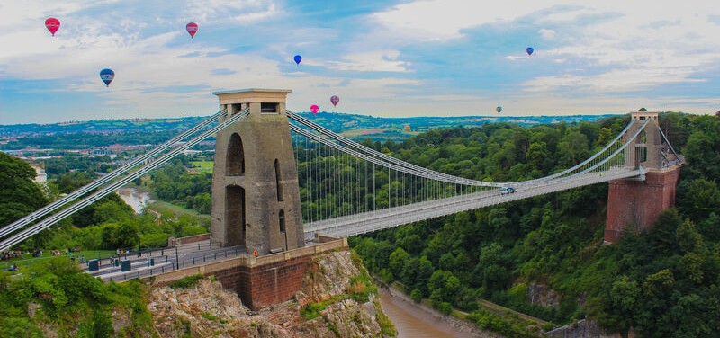 Image of Clifton Suspension Bridge in Bristol with hot air balloons flying overhead