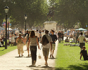 young people walking through Queen square park in the sunshine