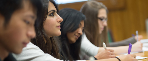 Students in a lecture hall taking notes