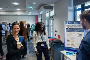 Stefania Akromah standing by her poster at the 2023 BCI Doctoral Research Symposium