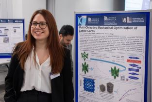 Athina Kontopoulou standing in front of her poster at the 2023 BCI Doctoral Research Symposium