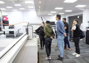 BCI researchers watching a demonstration of Thermoplastic Composites being digitally cut as part of a site visit to Zund UK. 