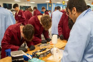 Two sixth form students reinforcing jelly moulds ready to test their samples with the NextCOMP crusher (in the foreground)