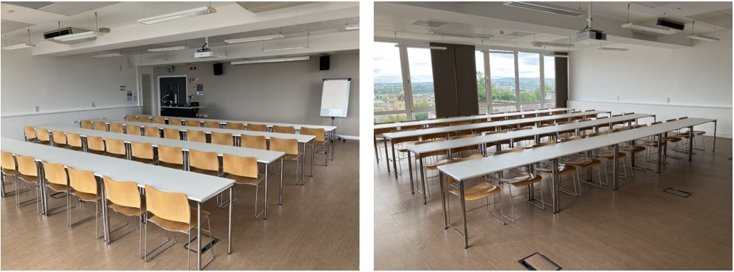 Chairs and tables in rows facing the teaching wall.