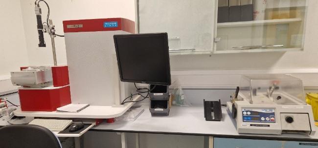 There are two instruments on a lab bench, on the left is the SEMPrep2 ion beam mill and on the right is the Isomet 1000 low-speed saw. There is a glass wall cabinet in the background.