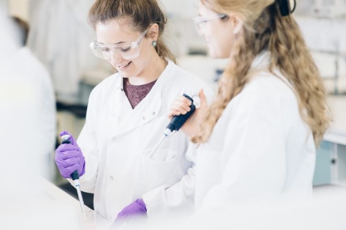 Students holding pipettes