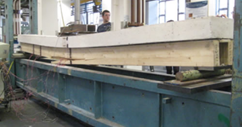 Researcher using beam test equipment in lab