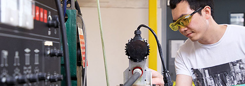 Mechanical Engineering student working on machinery